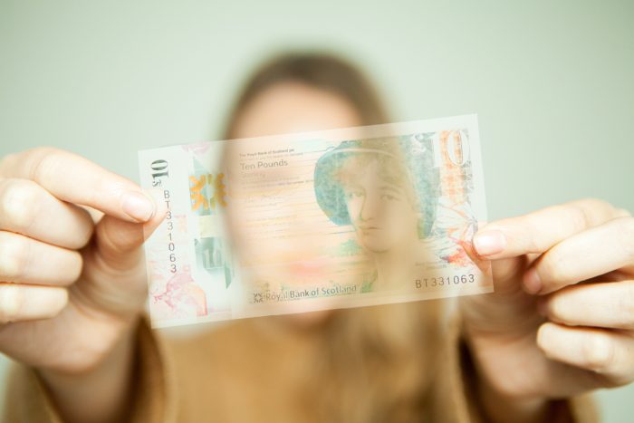 transparent money in front of blurred woman