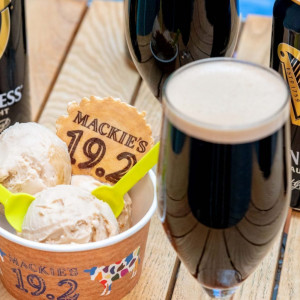 Scoops of the Guinness sorbet surrounded by pints of Guinness brandished with a 19.2 Mackie's wafer